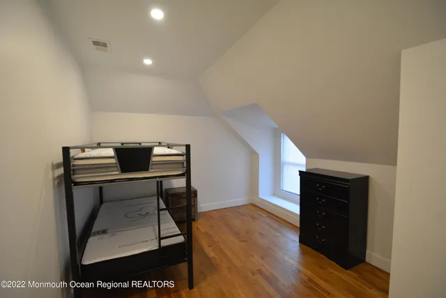 a view of a workspace with furniture and wooden floor