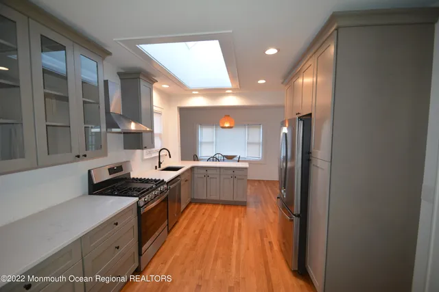 a kitchen with stainless steel appliances a refrigerator and a sink