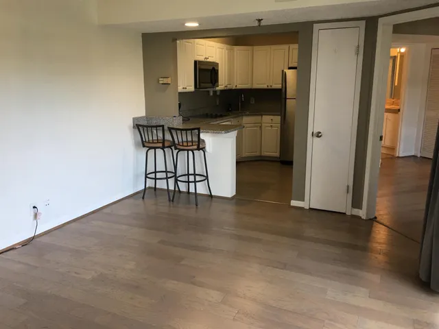 an empty room with kitchen appliances and windows