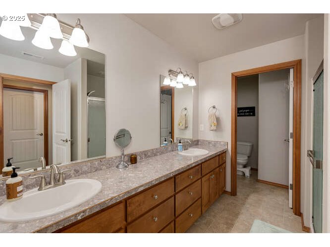 433 Southwest Pemberly Loop McMinnville, OR 97128 - Photo 14 of 24 a bathroom with a granite countertop sink a large mirror and a shower