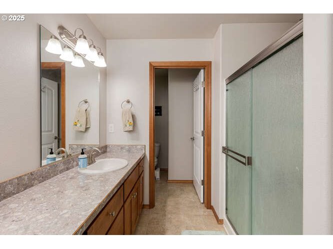 433 Southwest Pemberly Loop McMinnville, OR 97128 - Photo 15 of 24 a bathroom with a granite countertop sink a large mirror and a shower