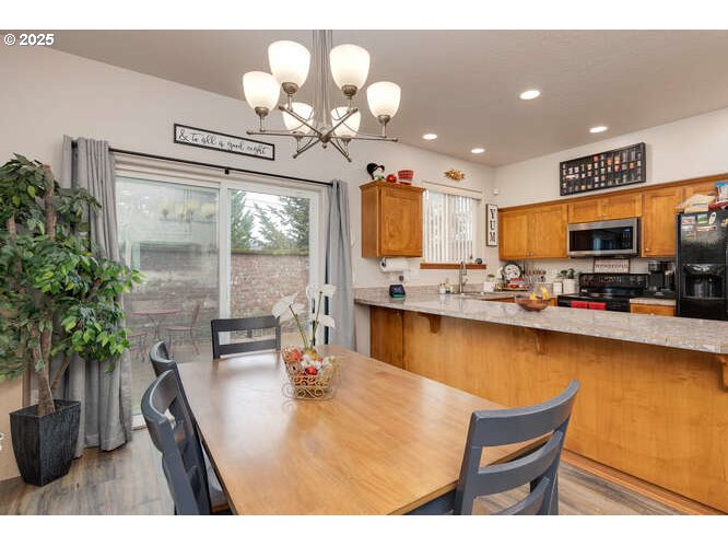 433 Southwest Pemberly Loop McMinnville, OR 97128 - Photo 9 of 24 a kitchen with sink cabinets and chandelier