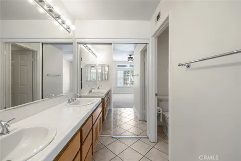 a bathroom with a double vanity sink mirror and shower