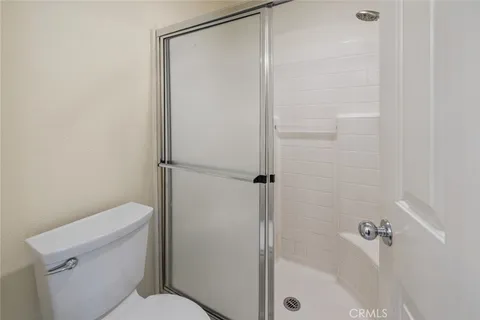 a bathroom with a shower a toilet and a shower