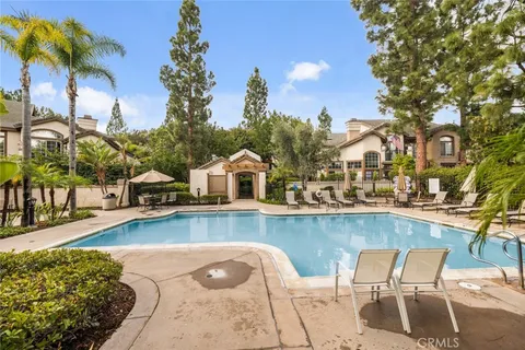 a view of a swimming pool with lounge chairs