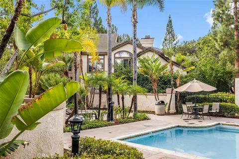 a view of a house with backyard and sitting area