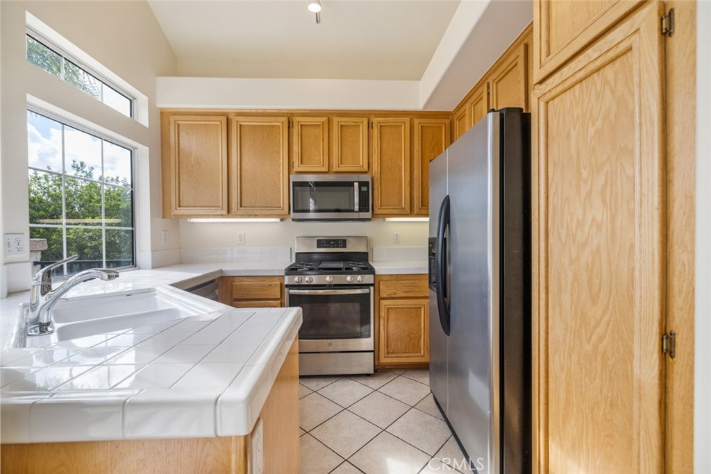 5 Montara Drive Aliso Viejo, CA 92656 - Photo 8 of 26 a kitchen with granite countertop a refrigerator stove top oven and sink