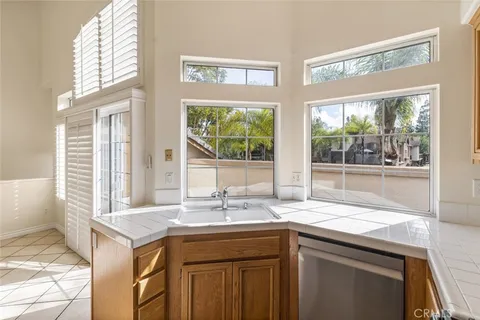 a kitchen with granite countertop a sink and a window