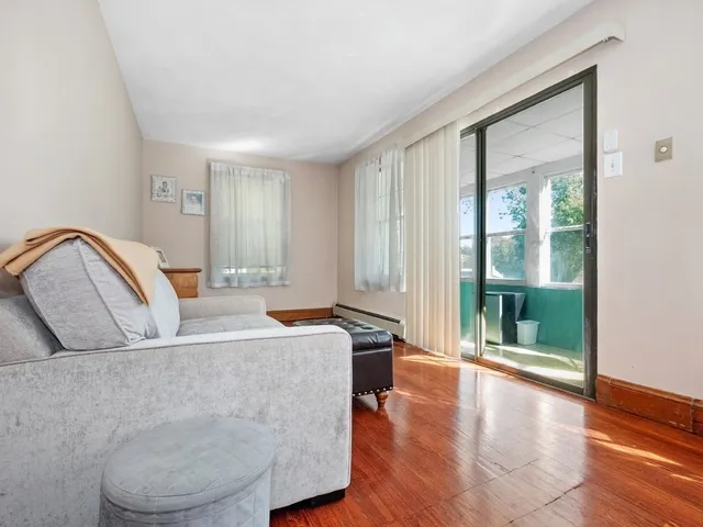 a living room with a couch and wooden floor