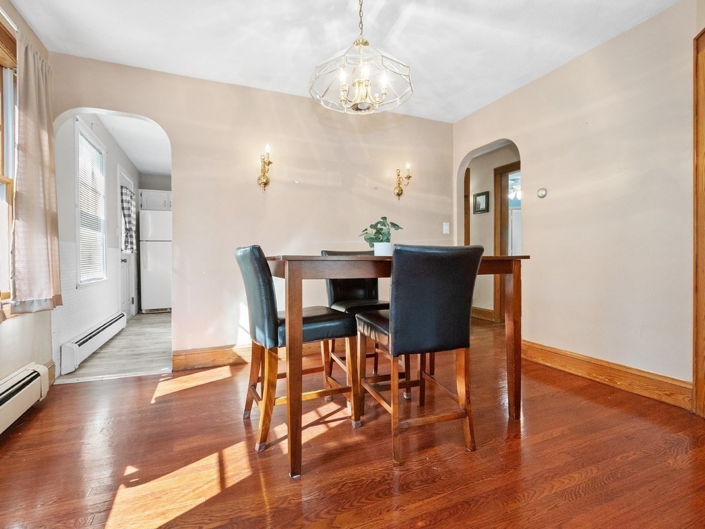 14 Willard Street Waltham, MA 02451 - Photo 14 of 36 a view of a dining room with furniture wooden floor and chandelier