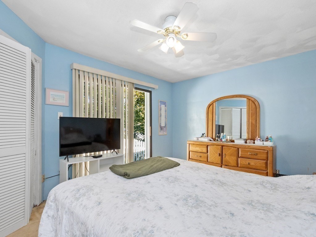 14 Willard Street Waltham, MA 02451 - Photo 20 of 36 a bedroom with a bed and a flat screen tv