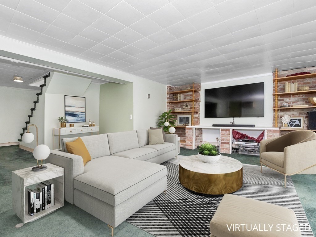 14 Willard Street Waltham, MA 02451 - Photo 24 of 36 a living room with furniture and a flat screen tv