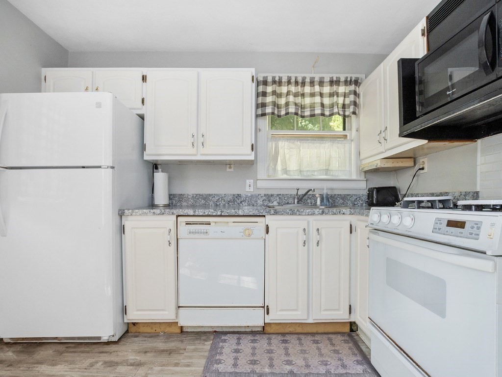 14 Willard Street Waltham, MA 02451 - Photo 7 of 36 a white refrigerator freezer sitting inside of a kitchen