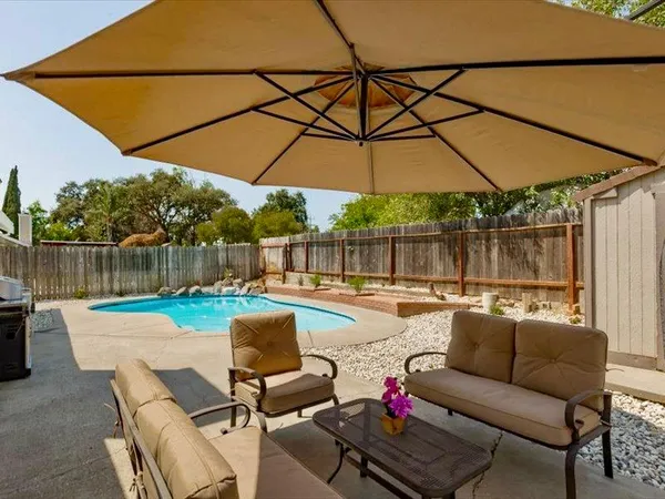 a patio with patio a couch and chairs