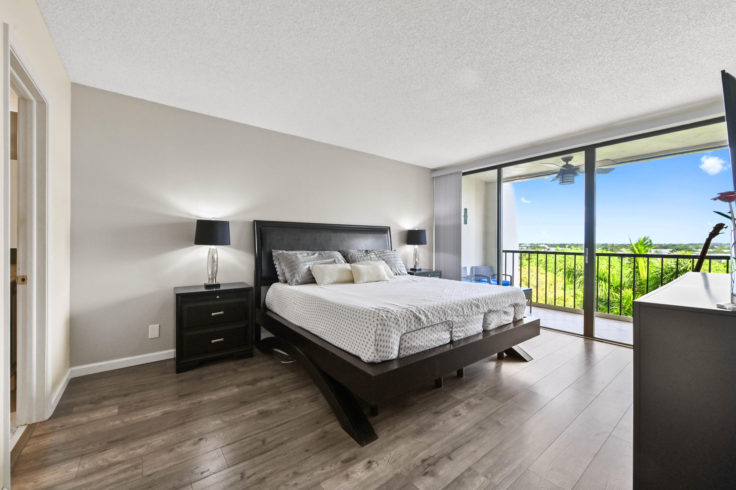 5951 Wellesley Park Drive, Unit 702 Boca Raton, FL 33433 - Photo 11 of 26 a bed sitting in a bedroom next to a window