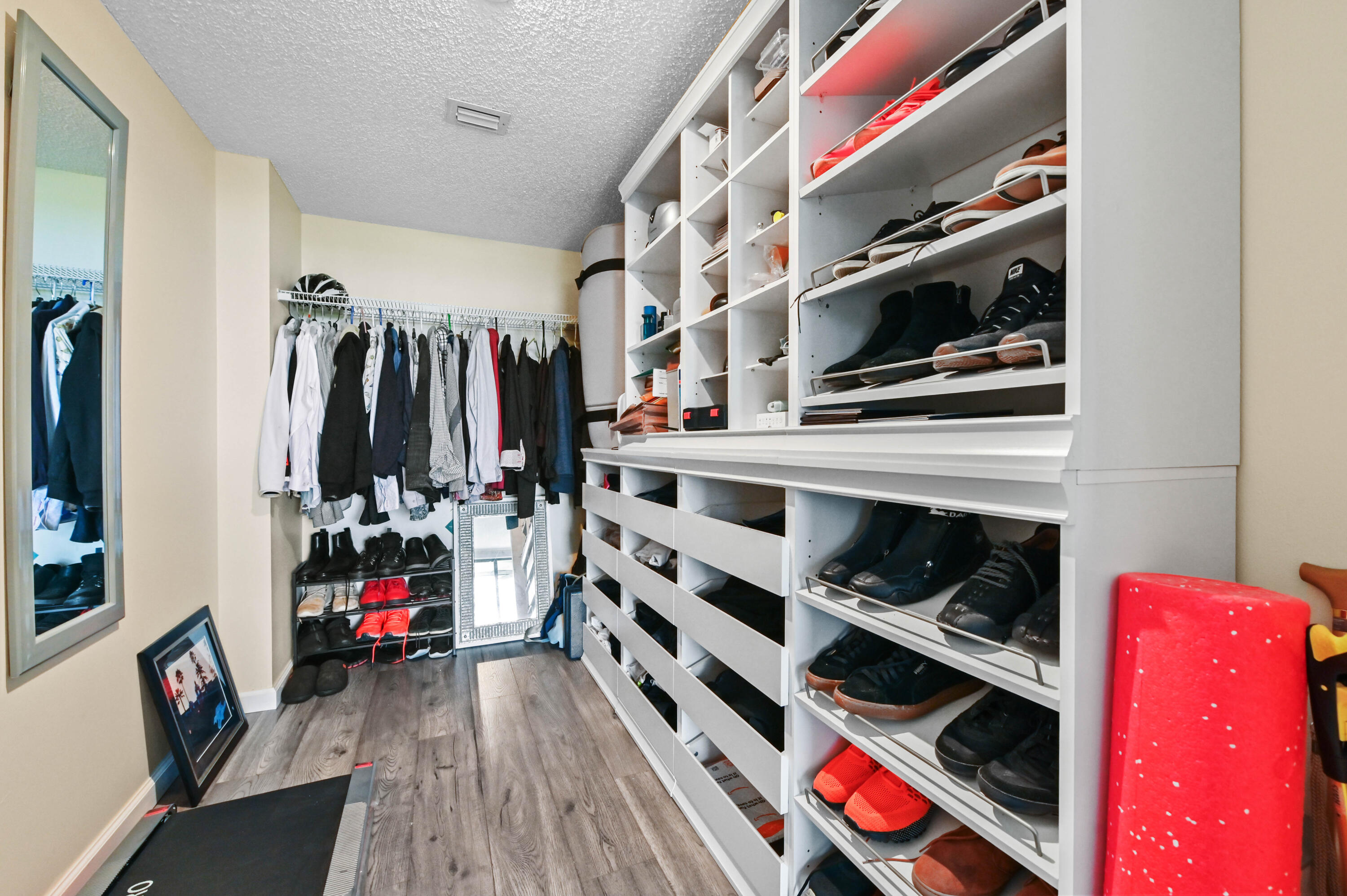 5951 Wellesley Park Drive, Unit 702 Boca Raton, FL 33433 - Photo 13 of 26 a view of walk in closet with clothes and shoes