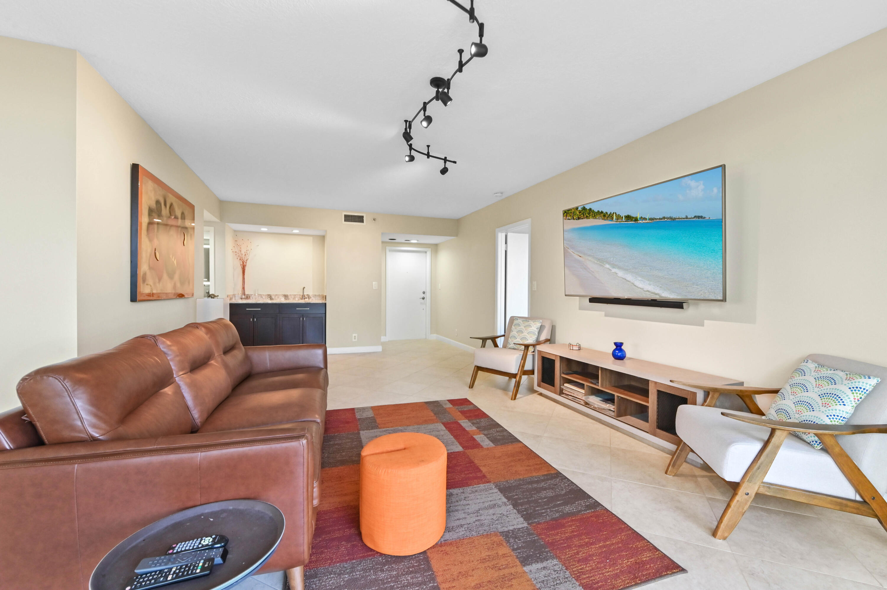 5951 Wellesley Park Drive, Unit 702 Boca Raton, FL 33433 - Photo 15 of 26 a living room with furniture and a flat screen tv