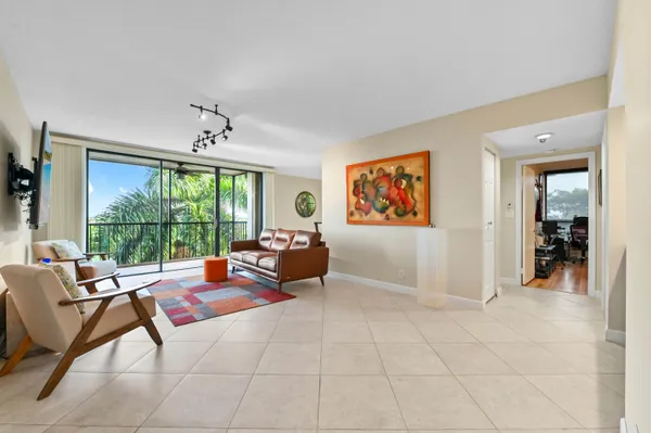 a living room with furniture and a floor to ceiling window