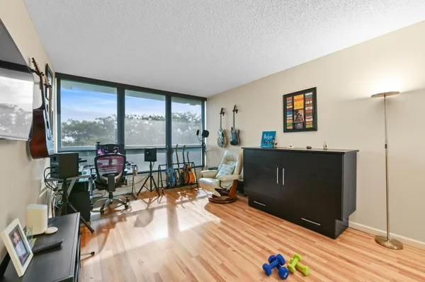 a living room with furniture and a flat screen tv with wooden floor