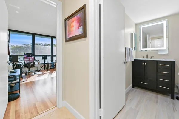 a hallway with a large window and wooden floor