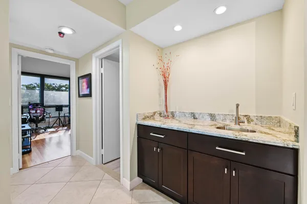 a view of bathroom with a sink and mirror