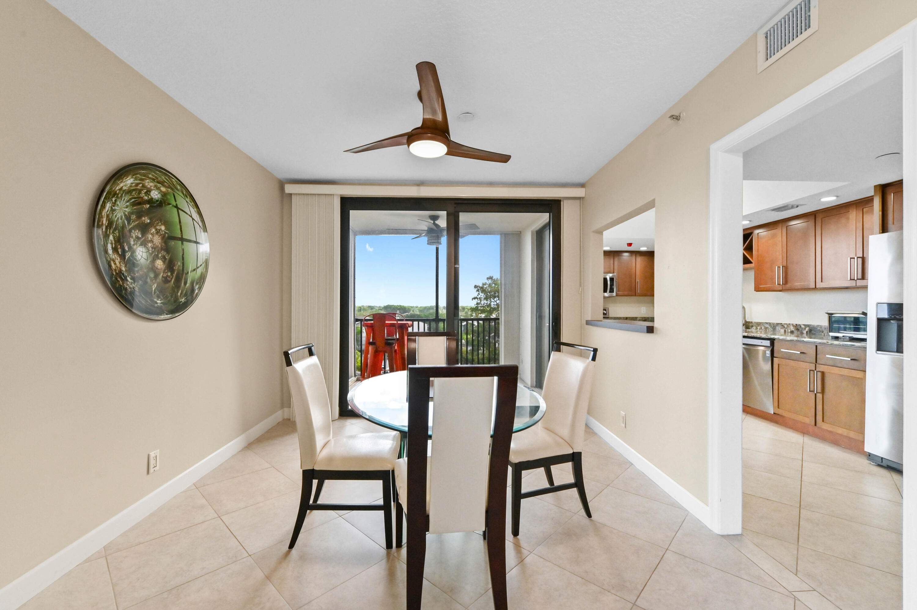 5951 Wellesley Park Drive, Unit 702 Boca Raton, FL 33433 - Photo 5 of 26 a view of a dining room with furniture window and wooden floor