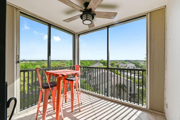 a balcony with an outdoor view and a potted plant