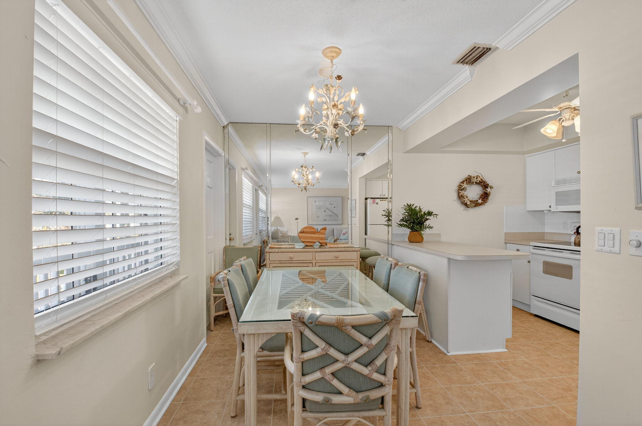 5505 North Ocean Boulevard, Unit 8204 Ocean Ridge, FL 33435 - Photo 11 of 47 a view of a dining room with furniture and a chandelier