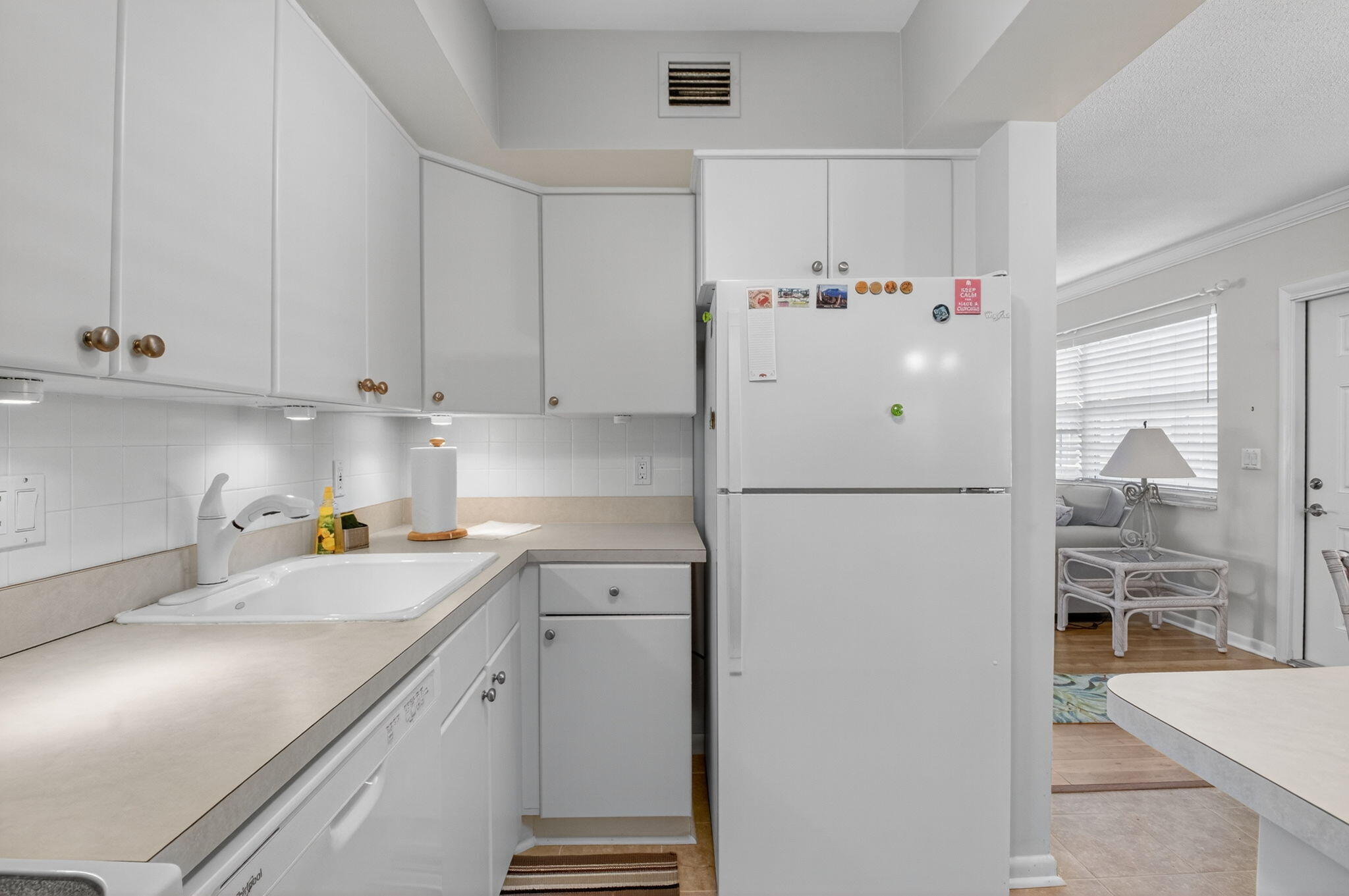 5505 North Ocean Boulevard, Unit 8204 Ocean Ridge, FL 33435 - Photo 14 of 47 a white refrigerator freezer sitting inside of a kitchen