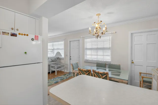 a kitchen with a sink a potted plant and cabinets
