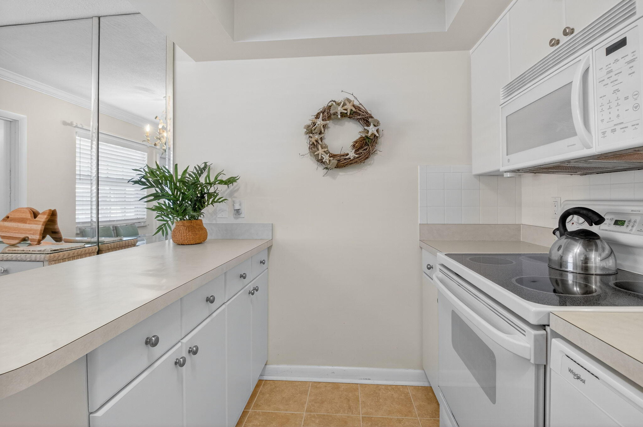 5505 North Ocean Boulevard, Unit 8204 Ocean Ridge, FL 33435 - Photo 16 of 47 a kitchen with a sink a potted plant and cabinets