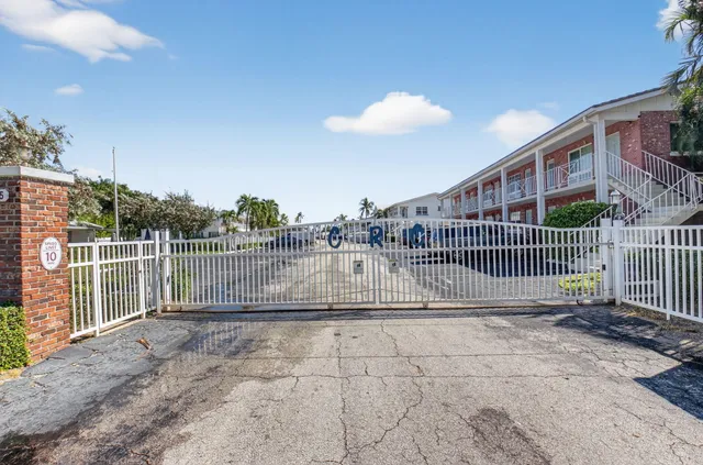 an aerial view of a house with swimming pool and outdoor seating