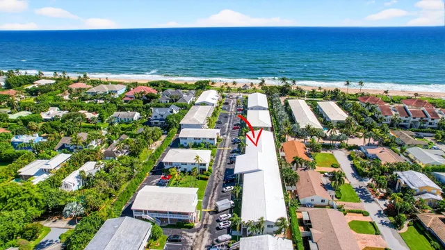 an aerial view of a residential houses with outdoor space and street view