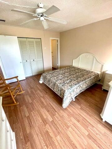 1225 Northwest 21st Street, Unit 343414 Stuart, FL 34994 - Photo 11 of 31 a bedroom with a bed and a dresser