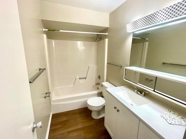 1225 Northwest 21st Street, Unit 343414 Stuart, FL 34994 - Photo 16 of 31 a bathroom with a granite countertop sink toilet and shower