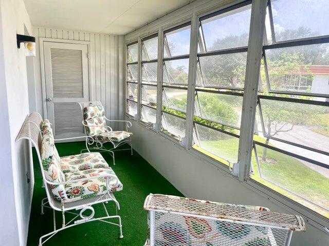 1225 Northwest 21st Street, Unit 343414 Stuart, FL 34994 - Photo 17 of 31 a balcony with furniture and a garden