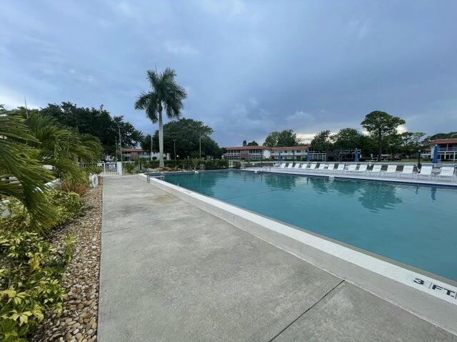 1225 Northwest 21st Street, Unit 343414 Stuart, FL 34994 - Photo 20 of 31 a view of a lake with a building in the background