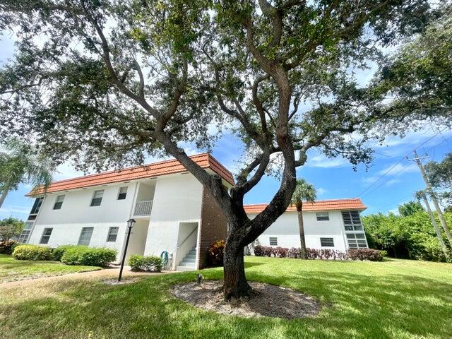 1225 Northwest 21st Street, Unit 343414 Stuart, FL 34994 - Photo 2 of 31 a front view of a house with a yard