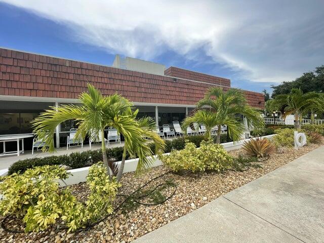 1225 Northwest 21st Street, Unit 343414 Stuart, FL 34994 - Photo 21 of 31 a front view of a house with a yard