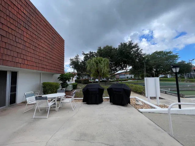 a view of a patio with chairs and tables