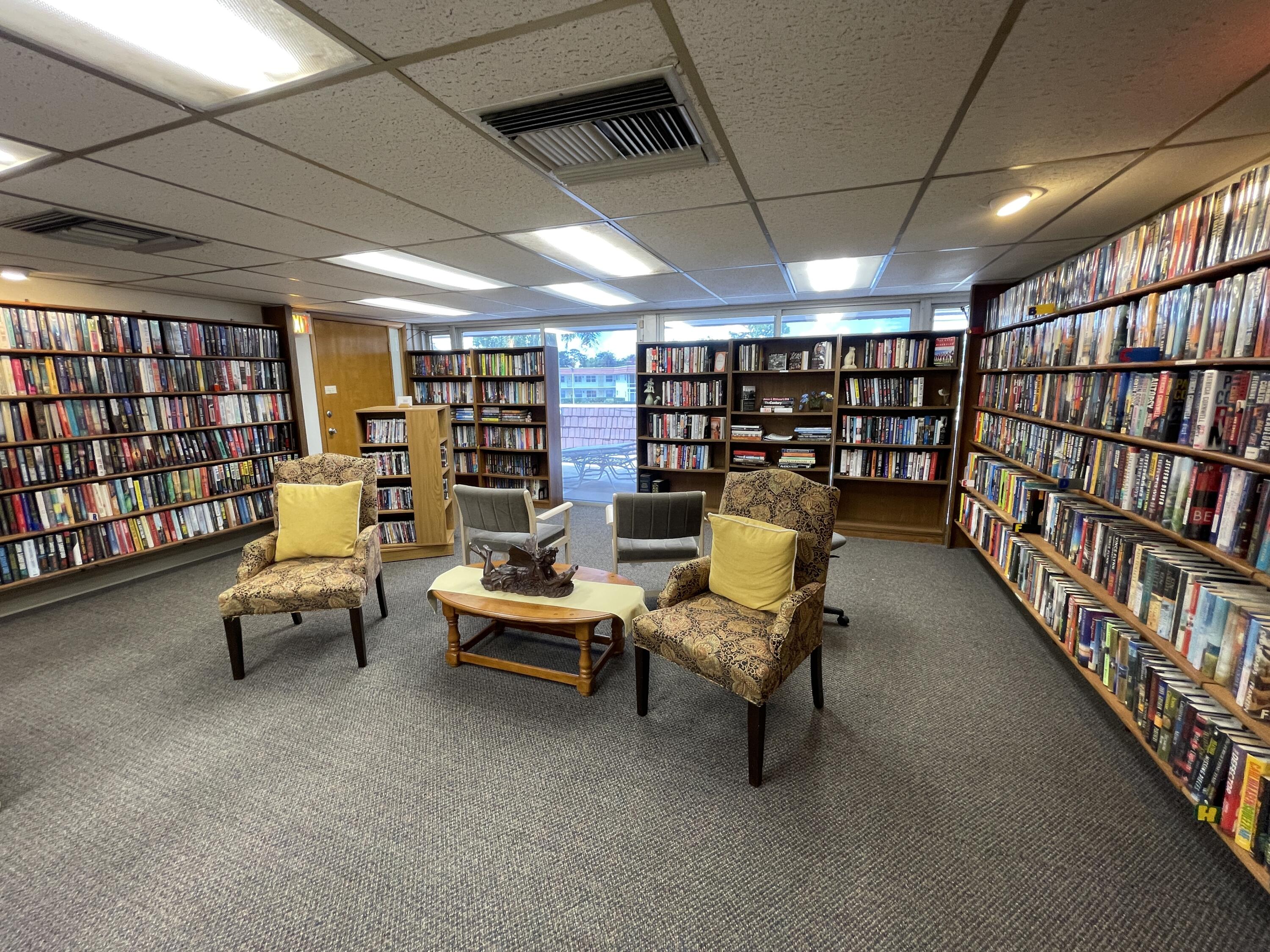 1225 Northwest 21st Street, Unit 343414 Stuart, FL 34994 - Photo 25 of 31 a reading room with furniture and book shelf