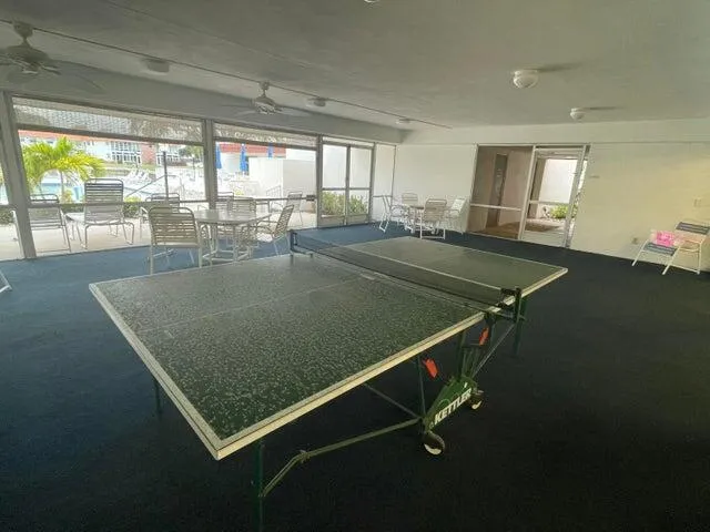 a room with pool table and windows