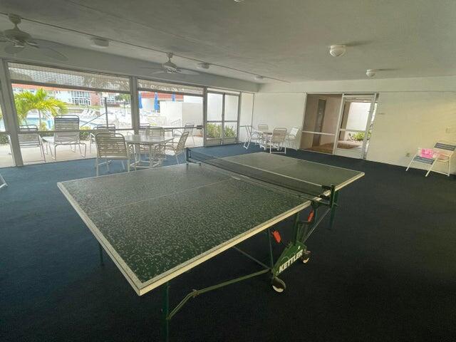 1225 Northwest 21st Street, Unit 343414 Stuart, FL 34994 - Photo 27 of 31 a room with pool table and windows