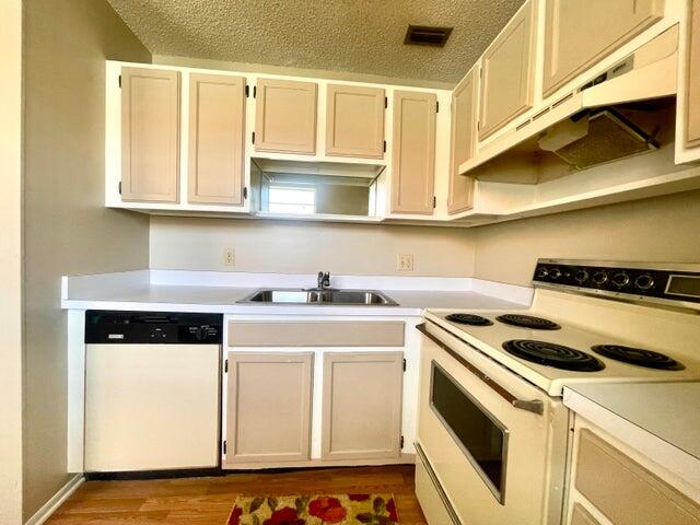 1225 Northwest 21st Street, Unit 343414 Stuart, FL 34994 - Photo 10 of 31 a kitchen with a stove cabinets and a microwave oven