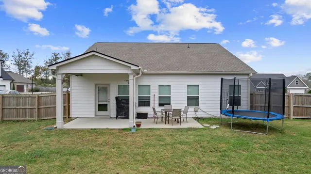 a front view of a house with a garden and yard