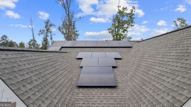 an aerial view of residential house with outdoor space and swimming pool