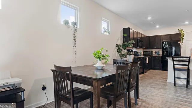 a view of a dining room with furniture and wooden floor