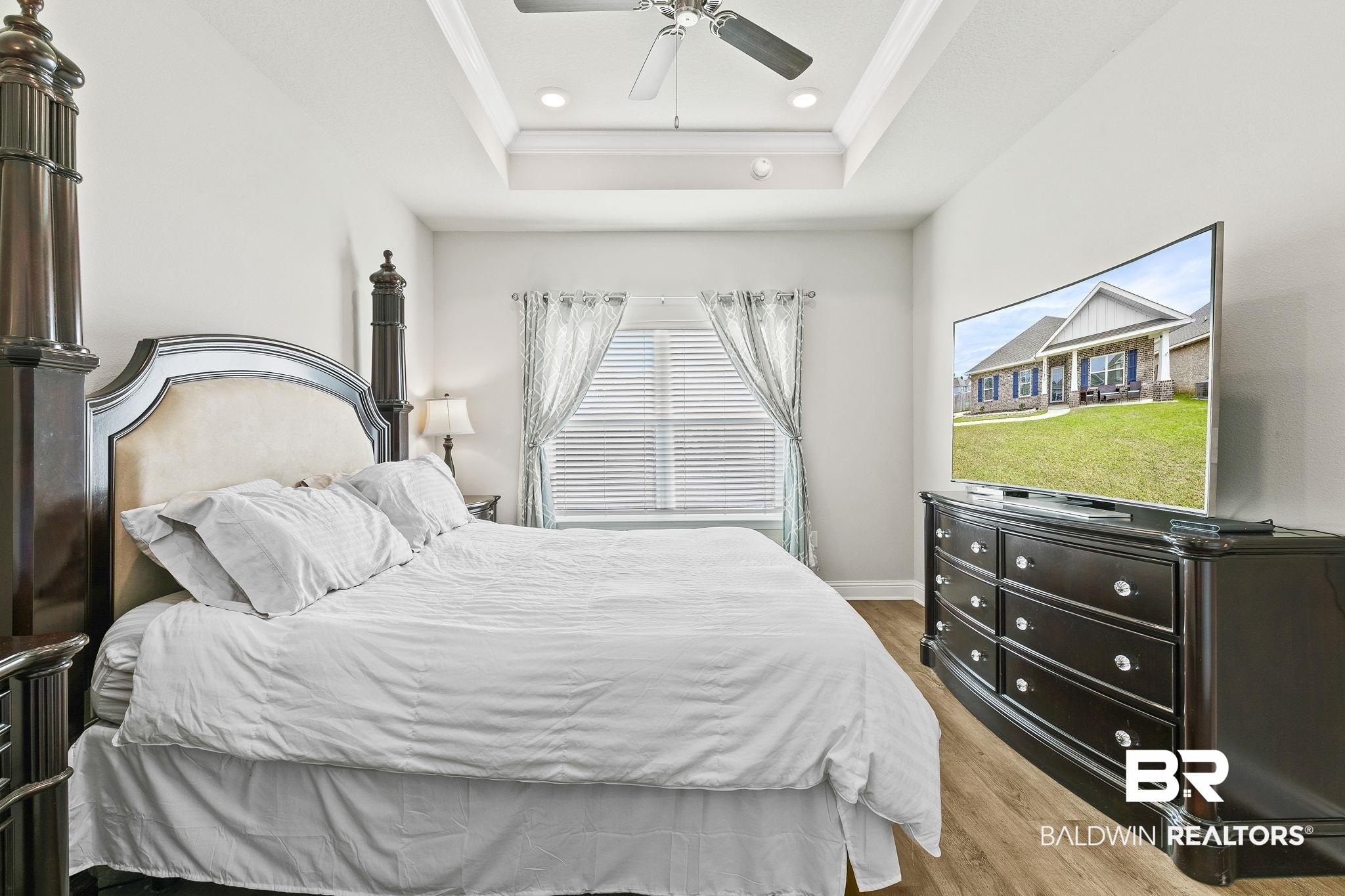 31610 Memphis Loop Daphne, AL 36527 - Photo 20 of 67 Bedroom featuring ornamental molding, a ceiling fan, a tray ceiling, wood finished floors, and recessed lighting