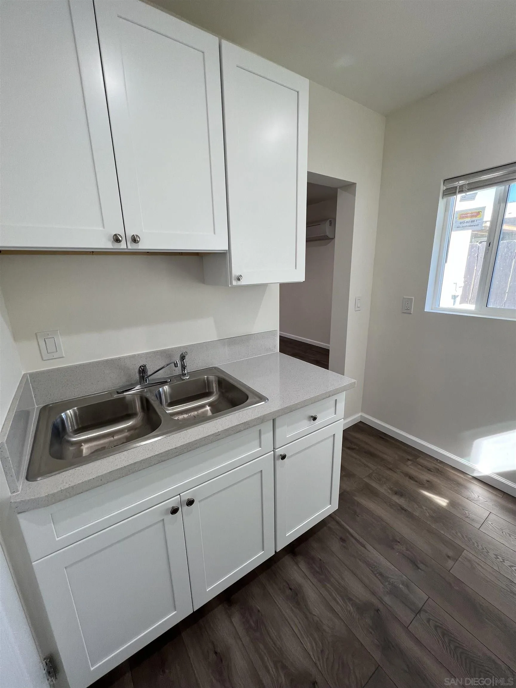 1223 Division Street Oceanside, CA 92054 - Photo 12 of 14 a kitchen with white cabinets and sink