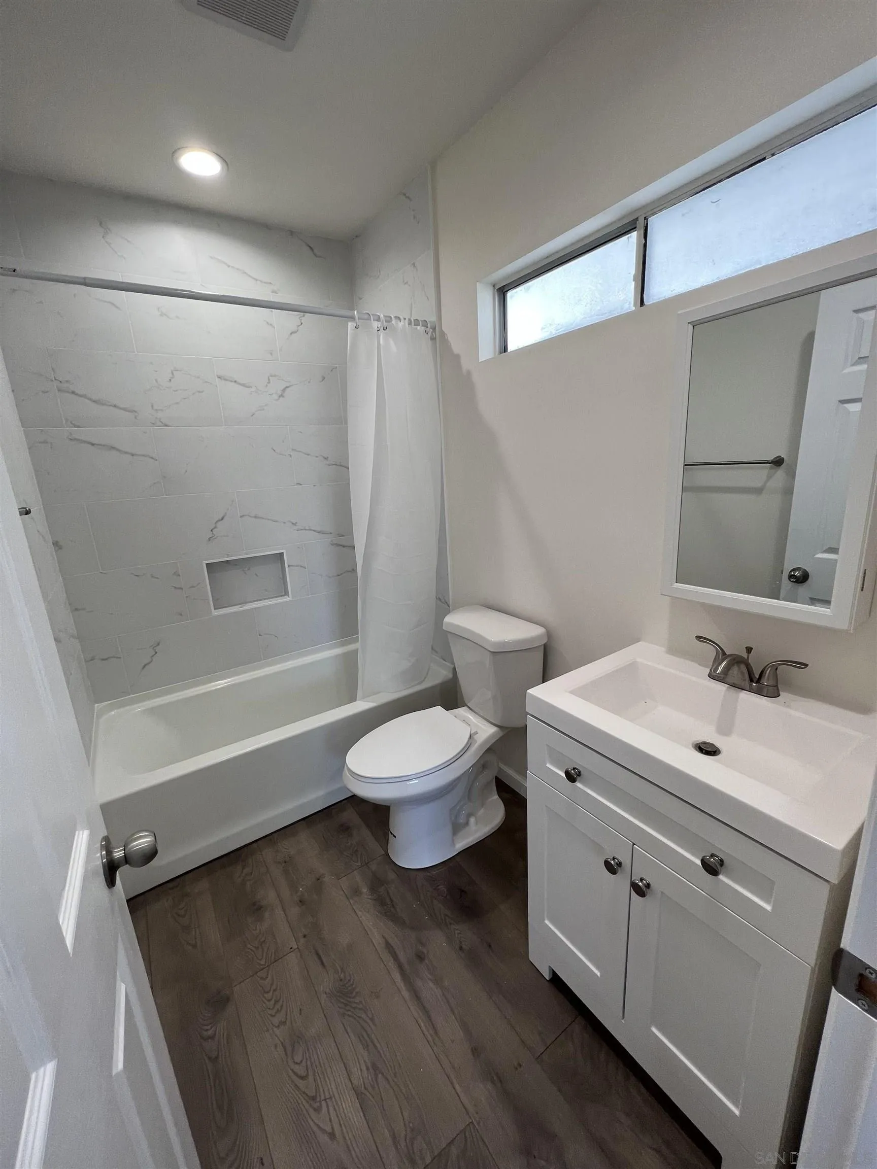 1223 Division Street Oceanside, CA 92054 - Photo 13 of 14 a bathroom with a sink a toilet and shower